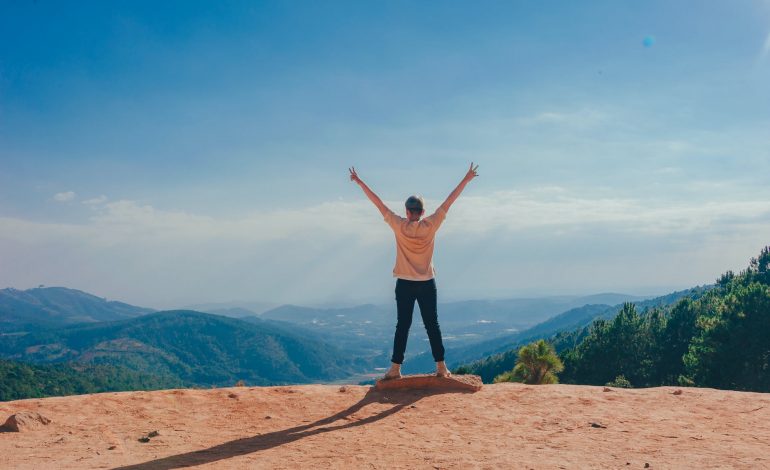 woman standing on cliff