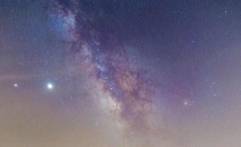 modern cars under sky with milky way