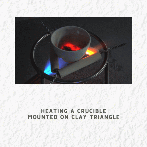 crucible on a clay triangle , tripod and bunsen burner equipment