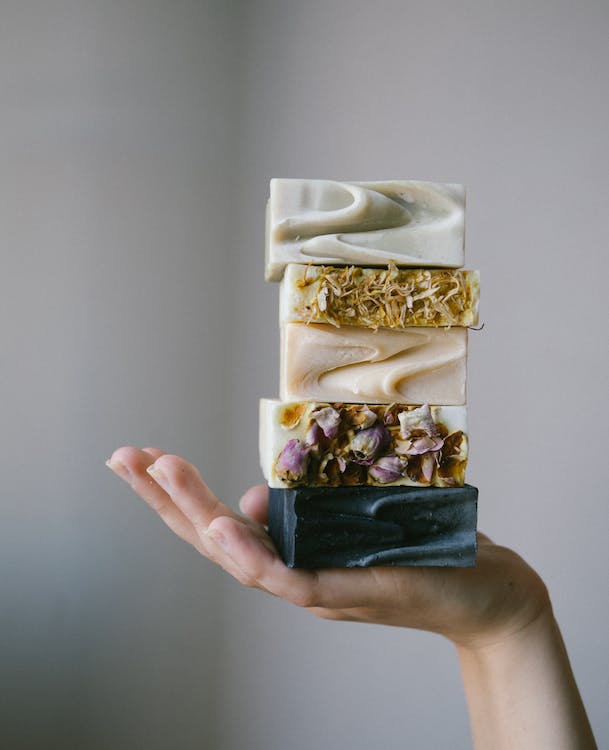 Free A Person Holding a Pile of Homemade Soap Stock Photo