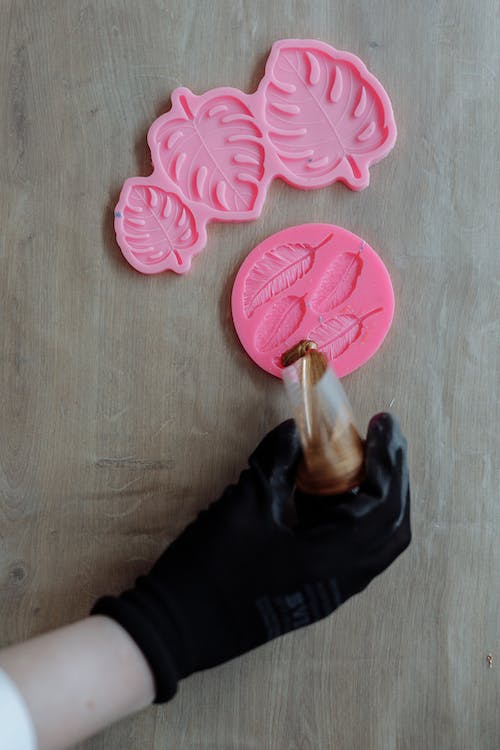 Free A Person Pouring Resin on a Mold Stock Photo