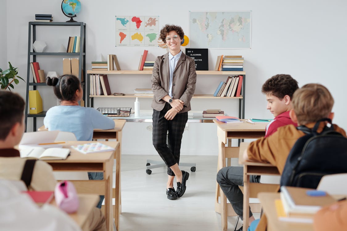 Free A Teacher Standing in the Classroom Stock Photo