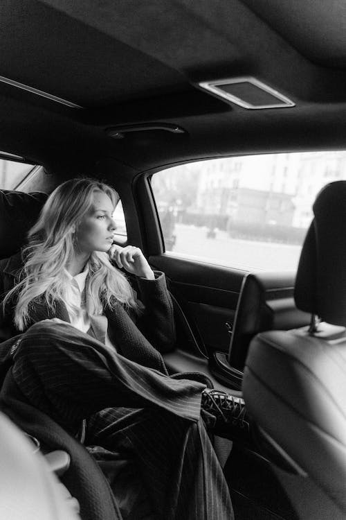 Free Grayscale Photo Of Woman Inside A Car Stock Photo