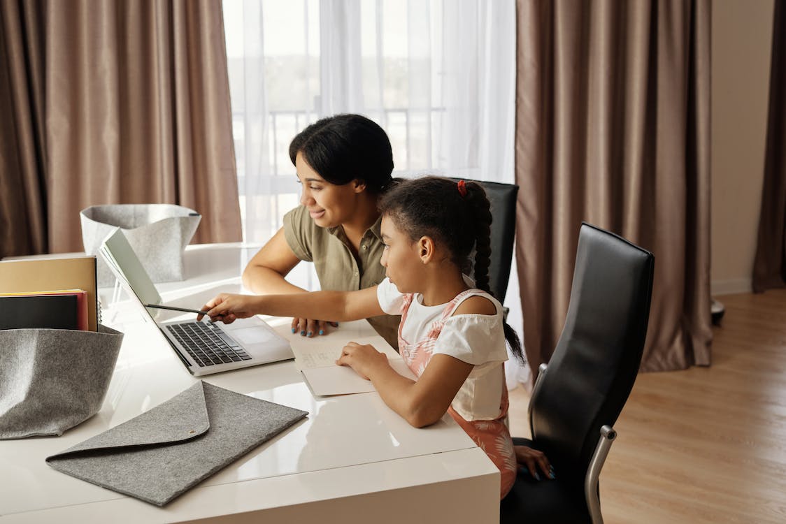 Free Mother Helping her Daughter with her Homework Stock Photo