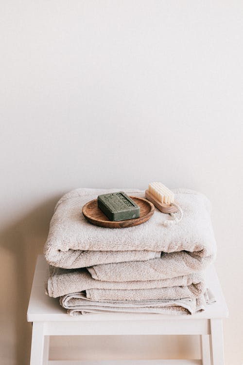 Free Natural toiletries and towels on stool Stock Photo