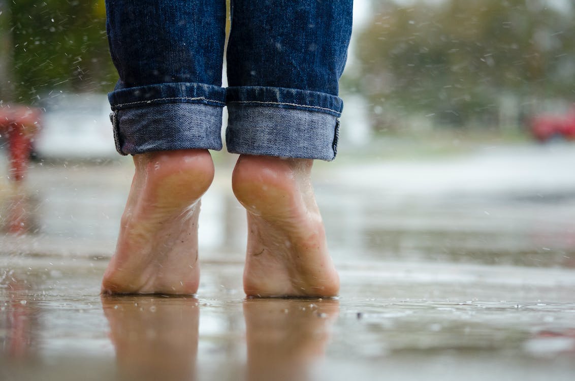 Free Person in Blue Denim Jeans Standing Outside the Rain Stock Photo