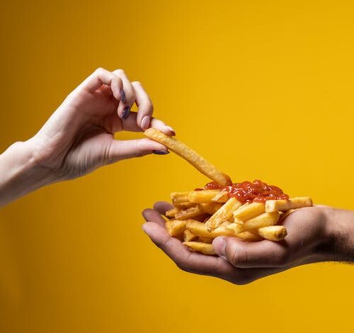 Free Person Sharing French Fries Stock Photo