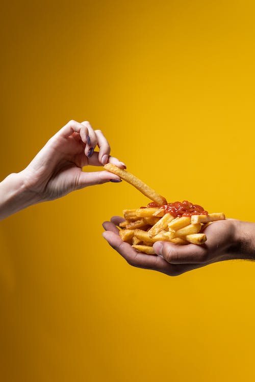 Free Person Sharing French Fries Stock Photo