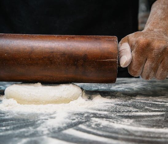 Free Person Using Brown Wooden Rolling Pin Stock Photo