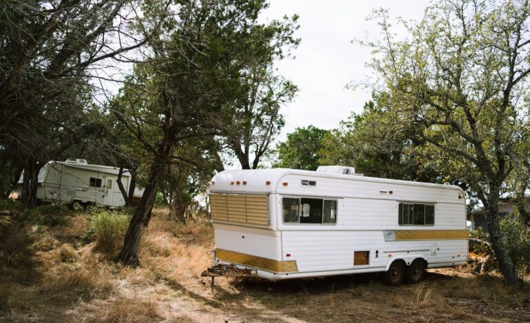 Free White and Brown Rv Trailer Near Green Trees Stock Photo