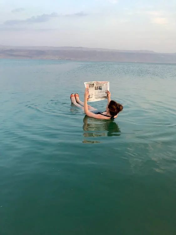 Free A Person Reading a Newspaper while Floating in the Dead Sea Stock Photo