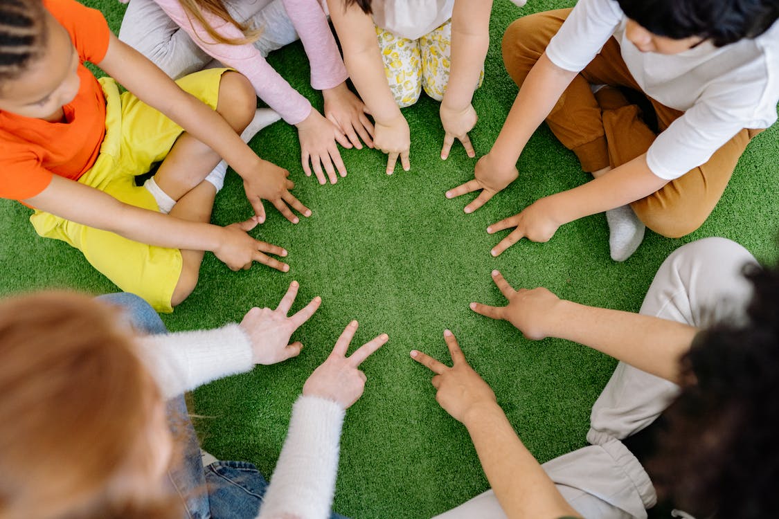 Free Group of Children Playing on Green Grass  Stock Photo