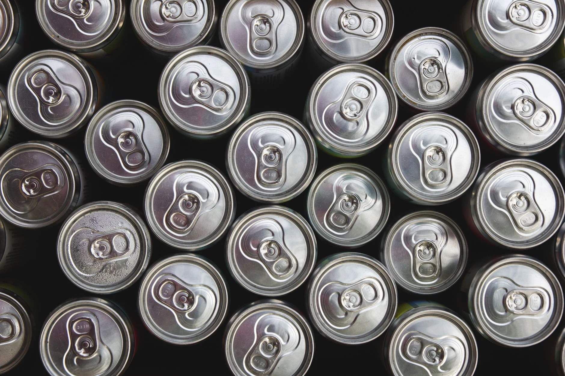 Rows of silver aluminium drink cans seen from above
