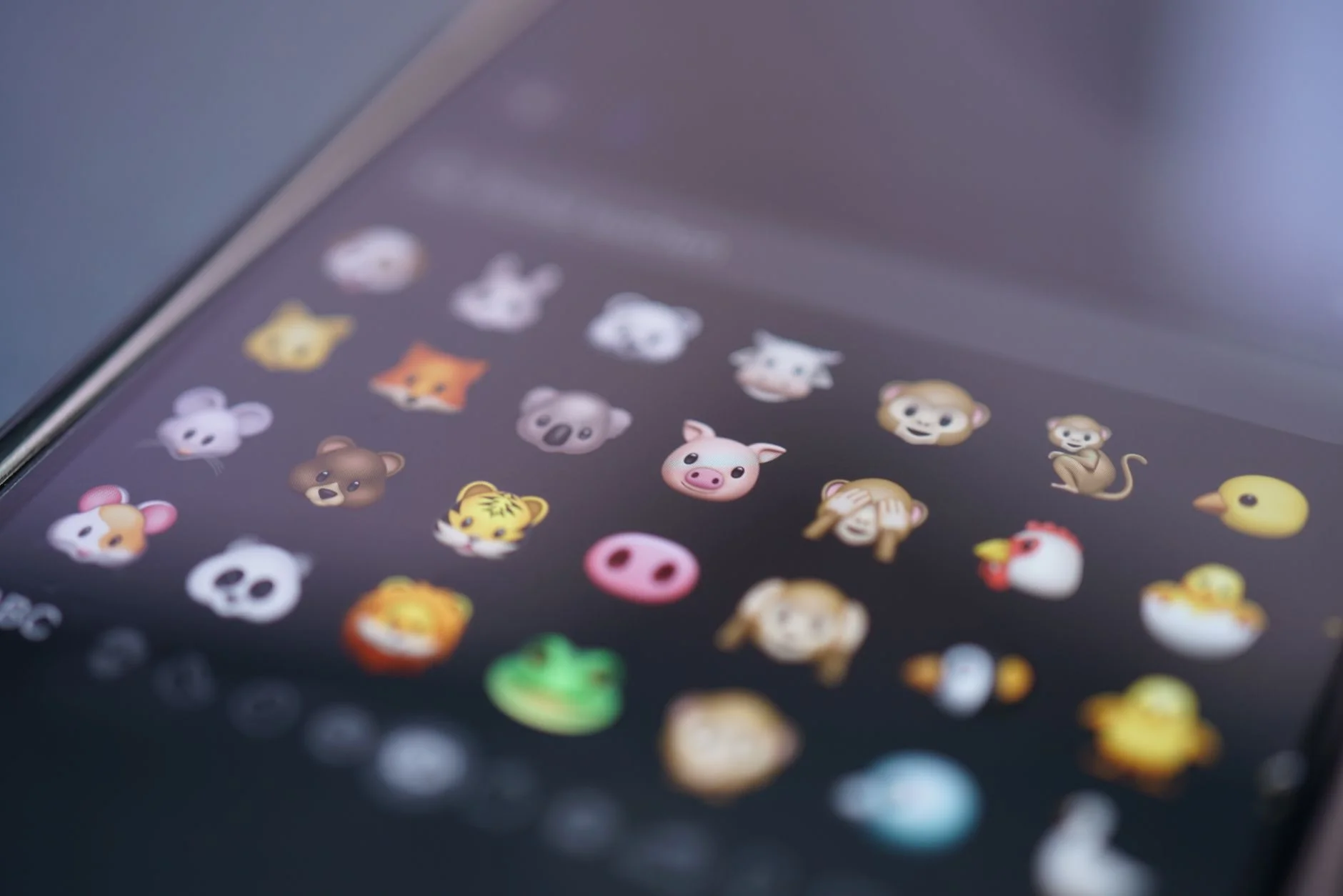 Close-up of animal face emojis on a smartphone emoji keyboard