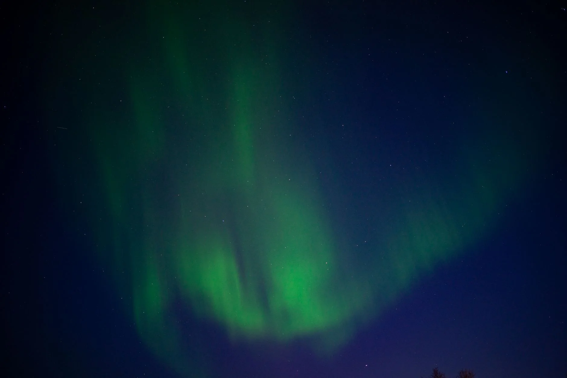 Green aurora borealis curtains glowing over Karasjok in northern Norway