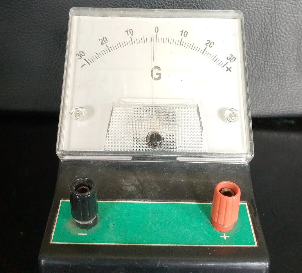 A school centre-zero galvanometer marked G, with a scale from 30 on the left through 0 in the middle to 30 on the right, and black and red terminals