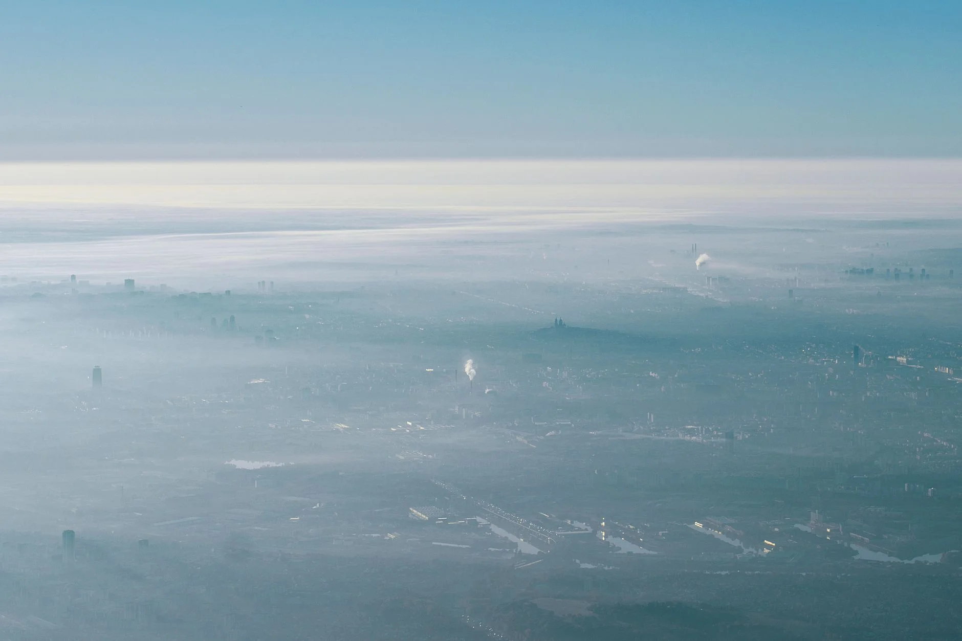 Hazy city skyline seen from the air on a sunny day
