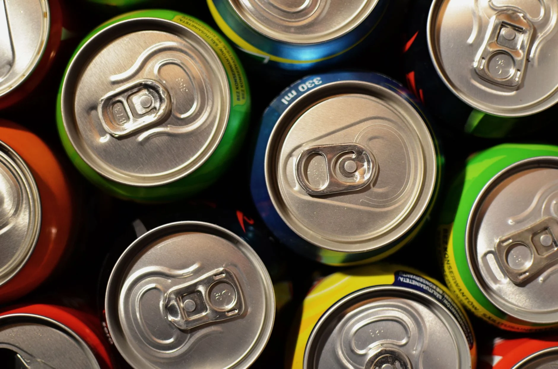 Rows of colourful drink cans seen from above