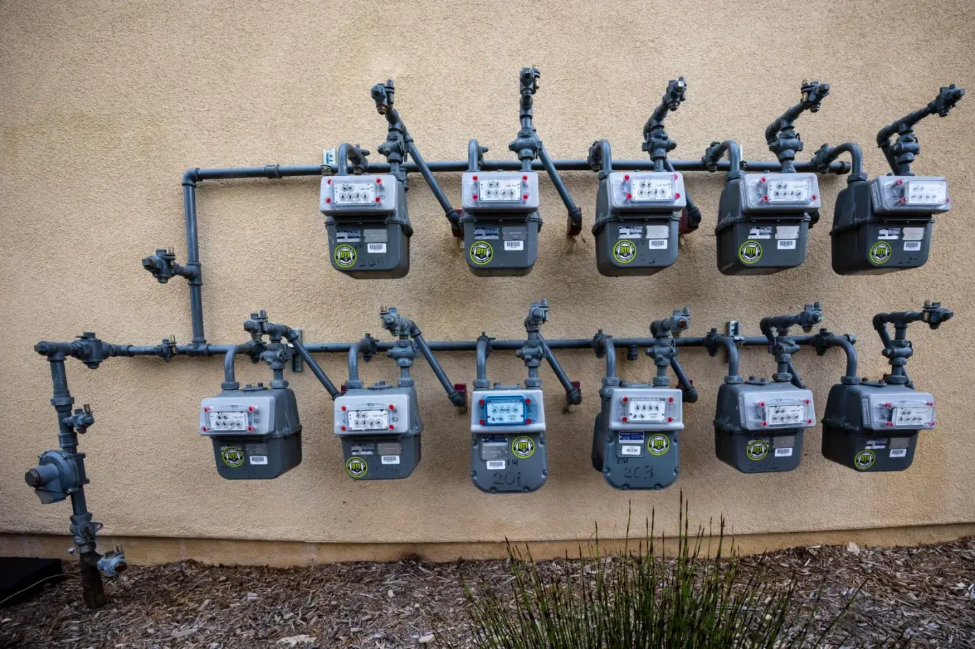 Row of US-style gas meters on an outside wall