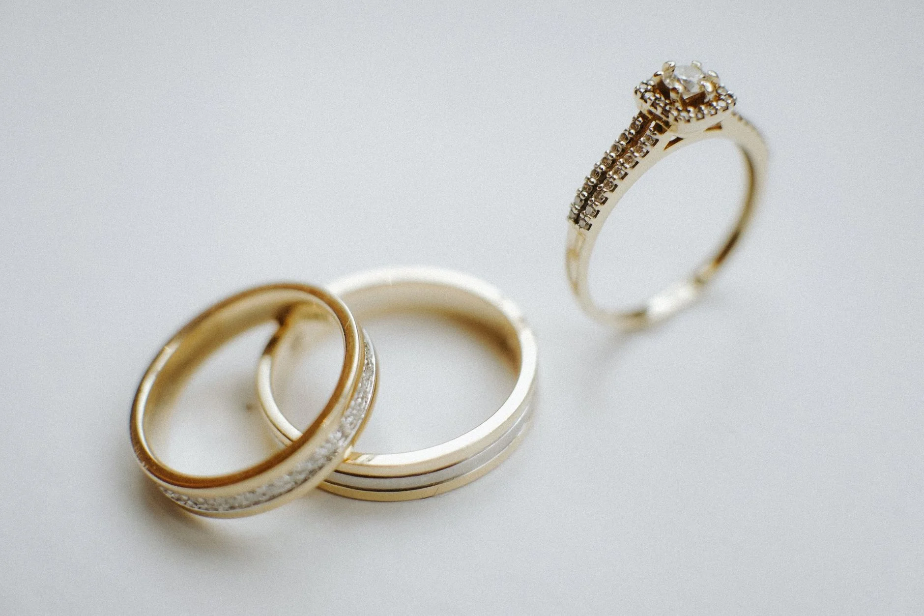 Gold wedding bands and a gold engagement ring made from hard-wearing gold alloy
