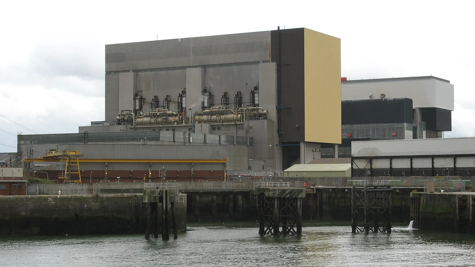 Heysham nuclear power station buildings beside the harbour wall in Lancashire