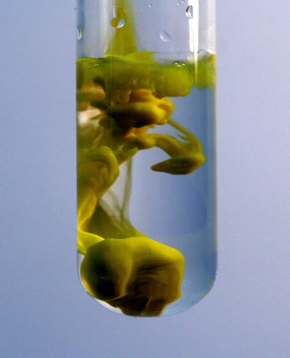 Yellow lead(II) iodide precipitate swirling in a test tube