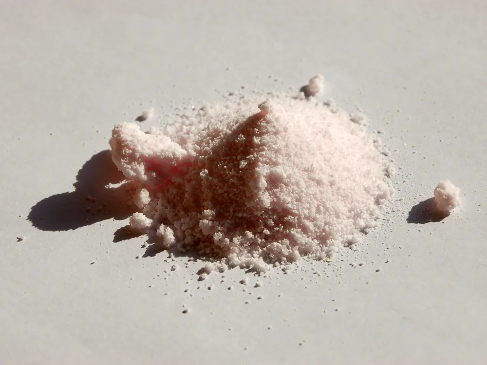 Pale pink crystals of manganese(II) sulfate