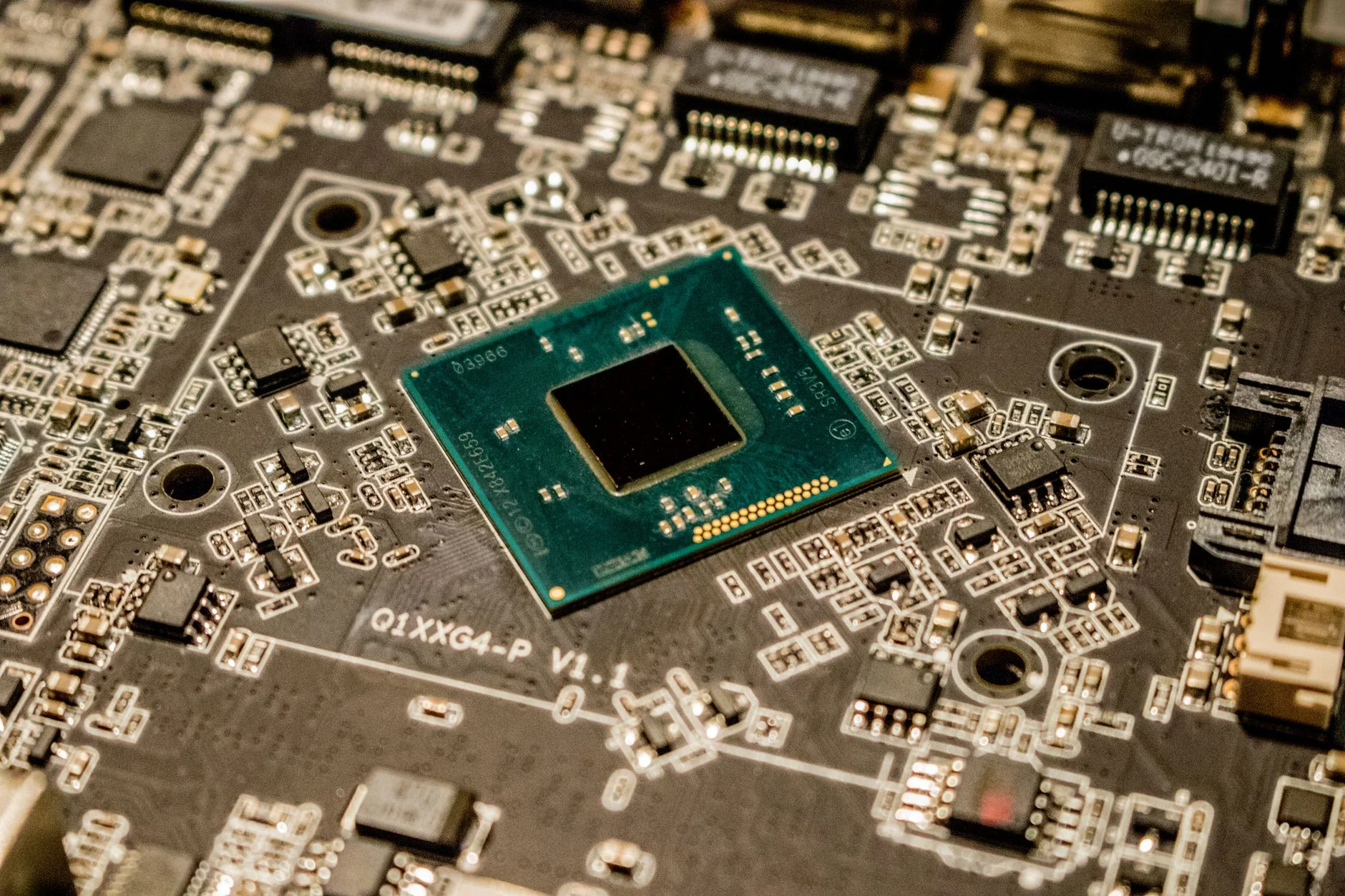 A green microprocessor chip mounted on a black circuit board