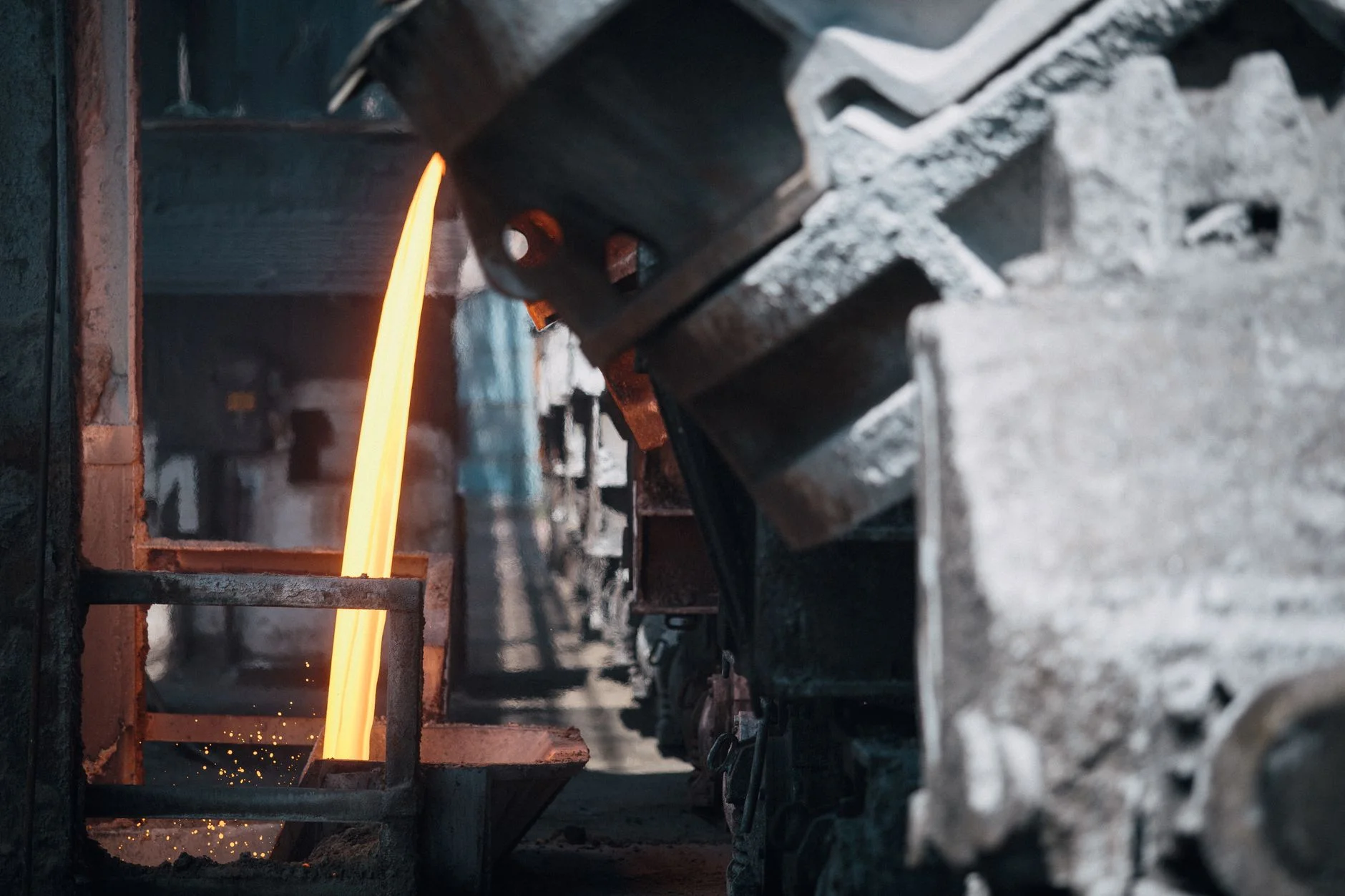 Molten metal pouring from a ladle in a steelworks