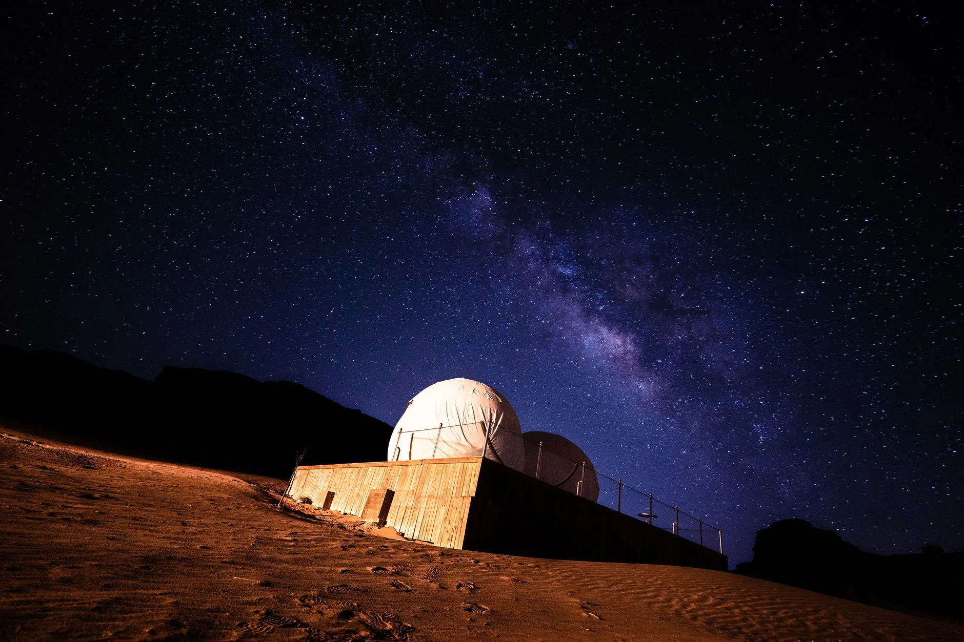 An observatory dome under the Milky Way on a clear, starry night