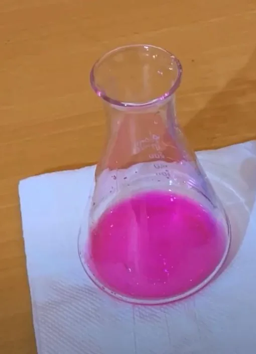 Conical flask of sodium hydroxide solution turned bright pink by phenolphthalein