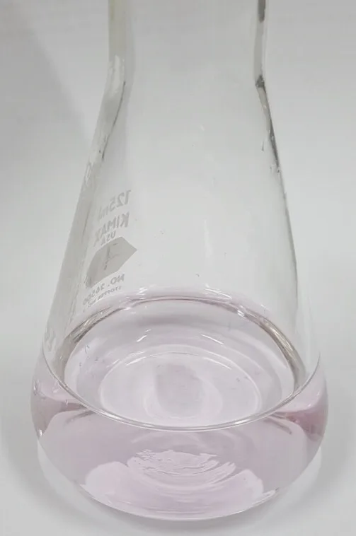 Conical flask with the faint pink colour of phenolphthalein at a titration end point
