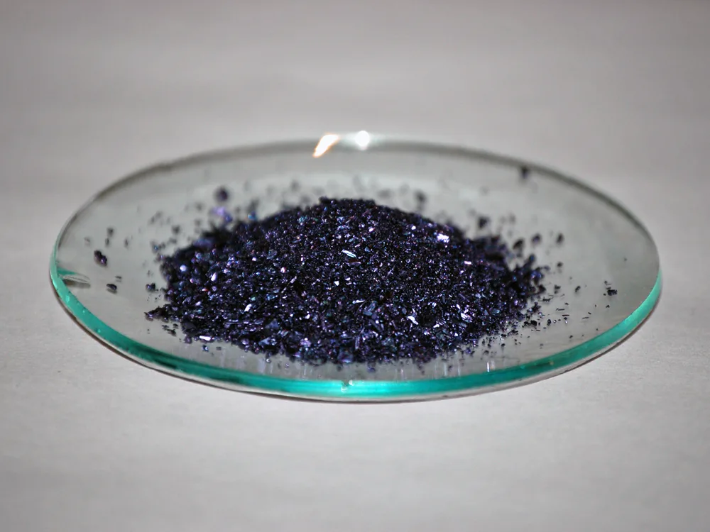 Potassium permanganate crystals on a glass watch glass