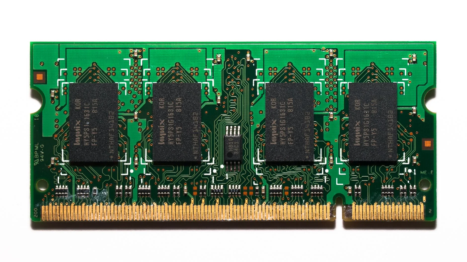 Laptop SO-DIMM memory module with four black DRAM chips on a green circuit board