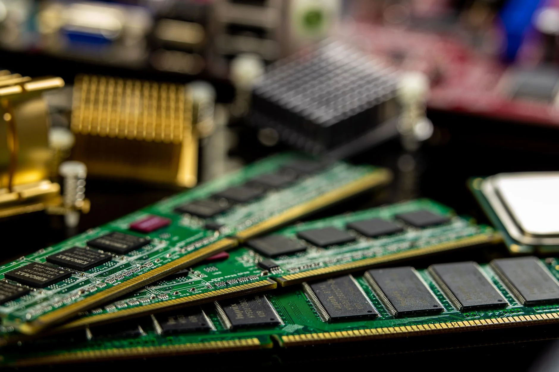 Several green RAM sticks resting on a motherboard