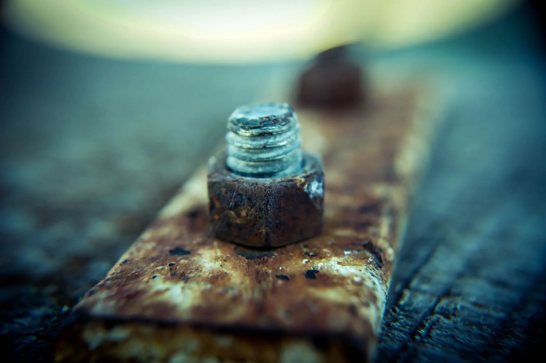 Rusty nut and bolt on a corroded iron bar