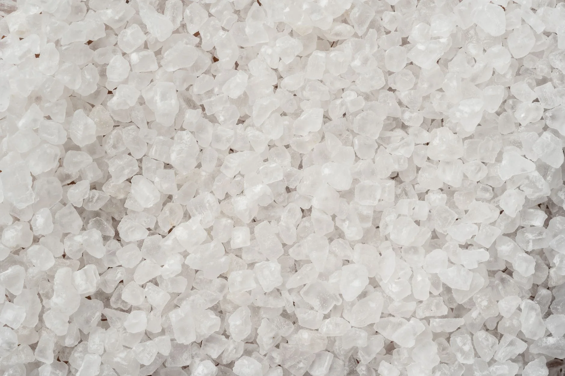 Coarse white salt crystals close up