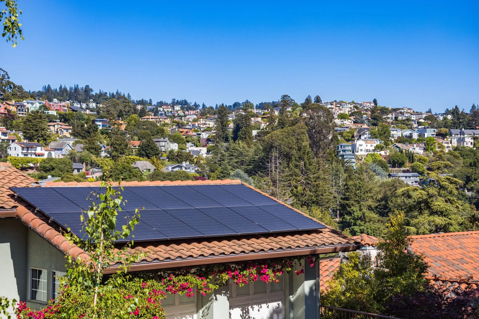 Rooftop solar panels on a suburban house on a sunny day