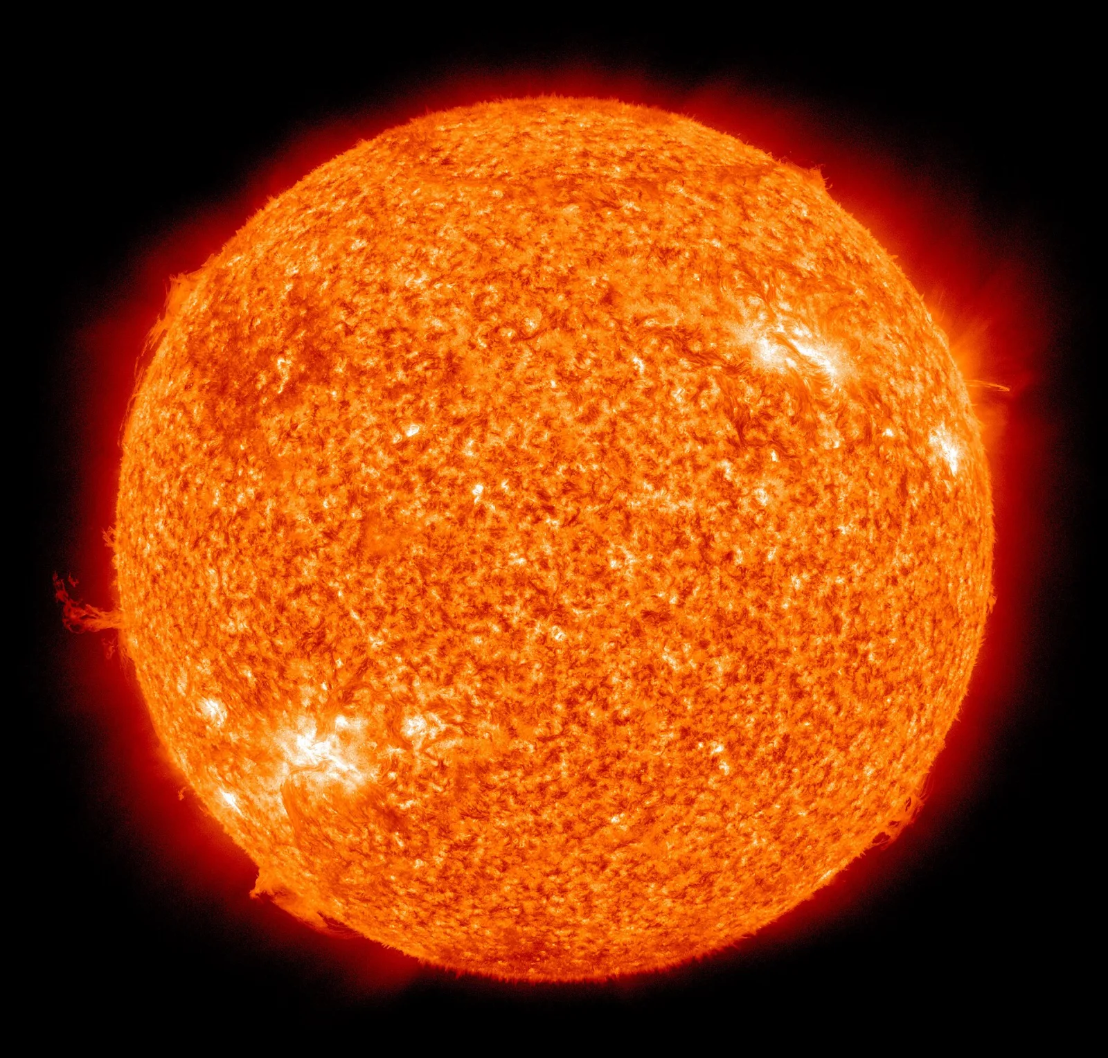 The Sun seen as a glowing orange ball with bright active regions, photographed by NASA’s Solar Dynamics Observatory