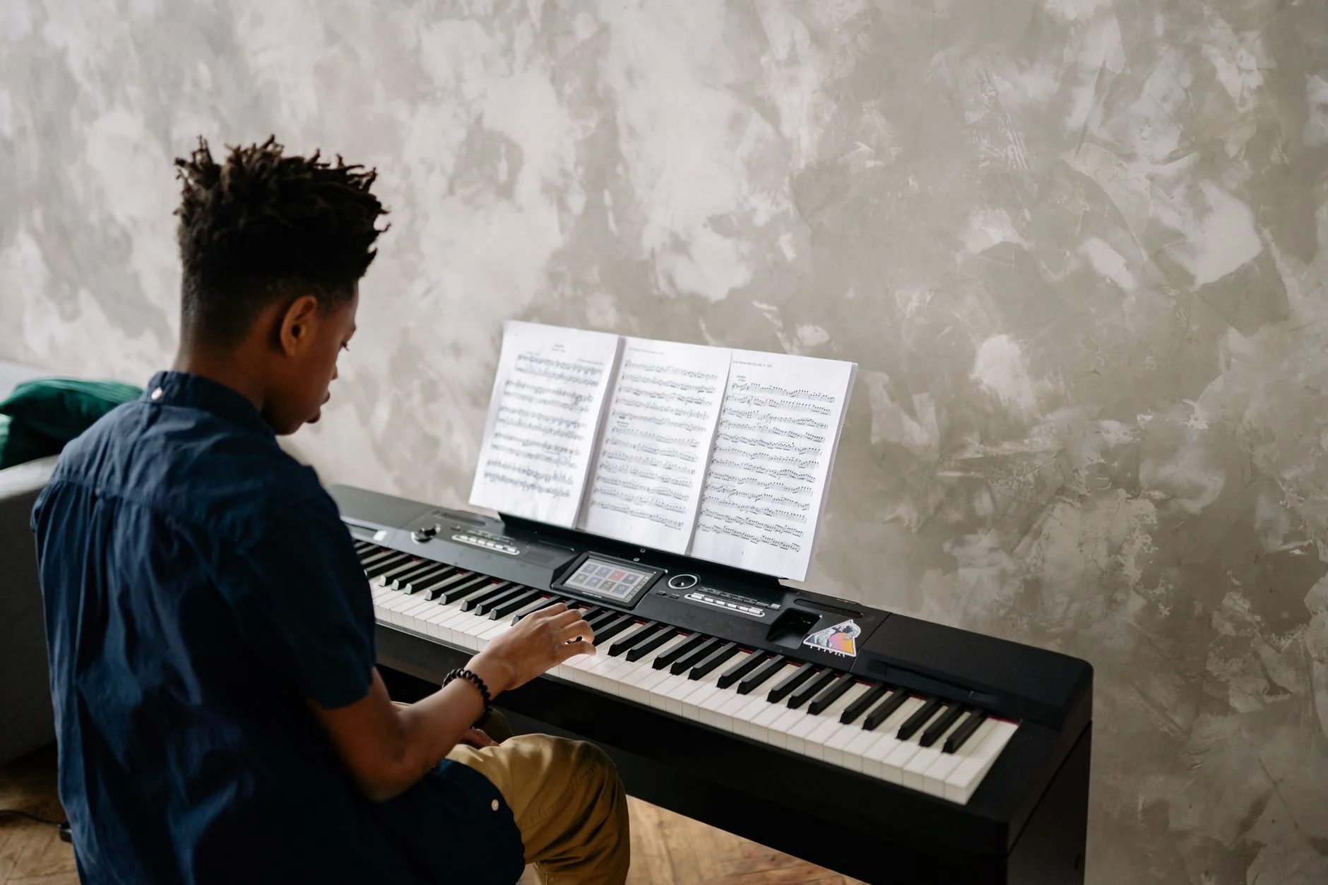 A teenager practising the piano with focus