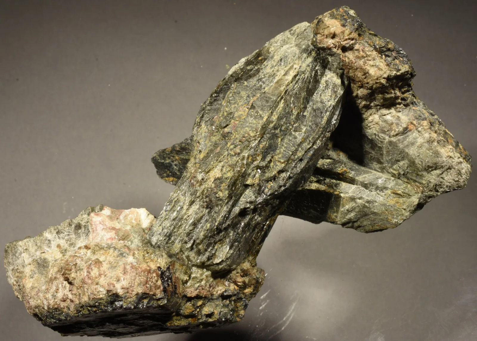 Greenish-grey crystals of thortveitite, the main scandium mineral, on feldspar from Kåbuland, Norway