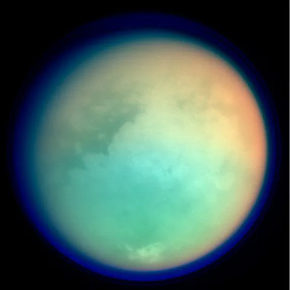 Titan seen in infrared by Cassini, showing dark and bright surface regions through the haze