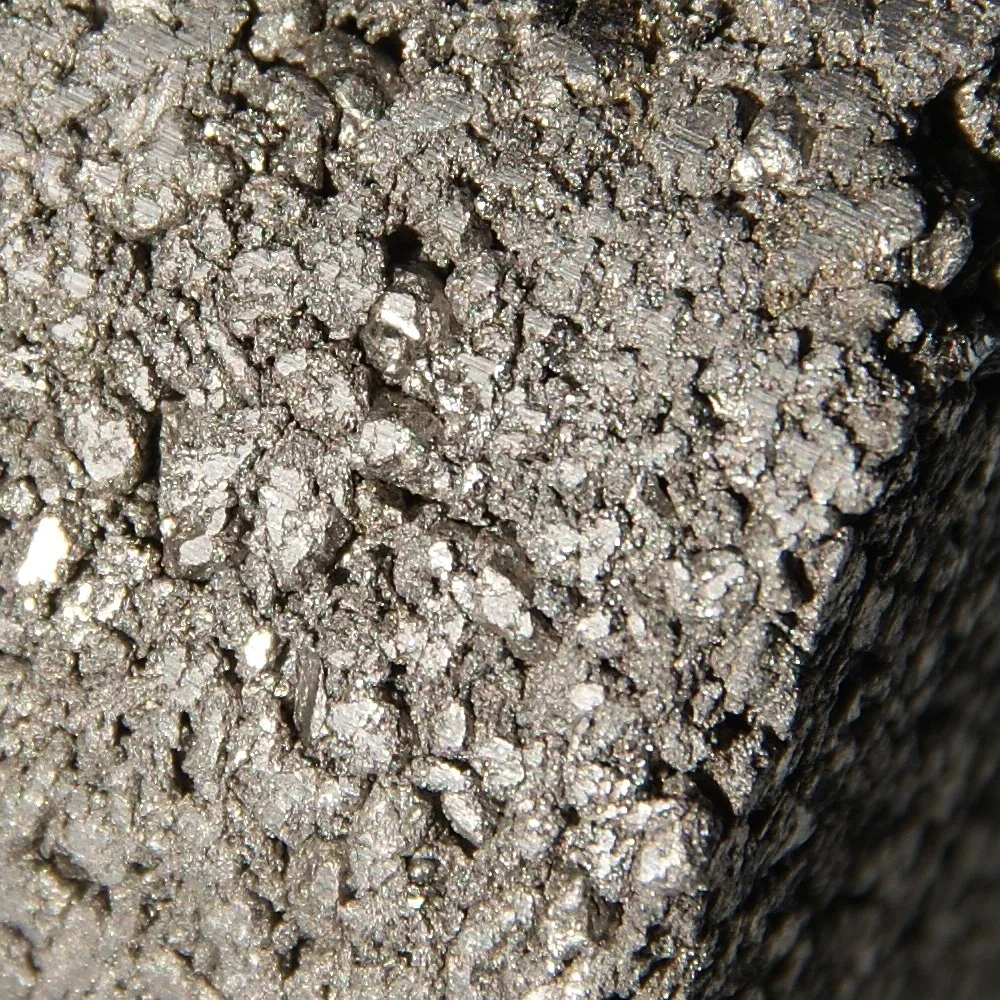 Close-up of grey, porous titanium sponge made by the Kroll process