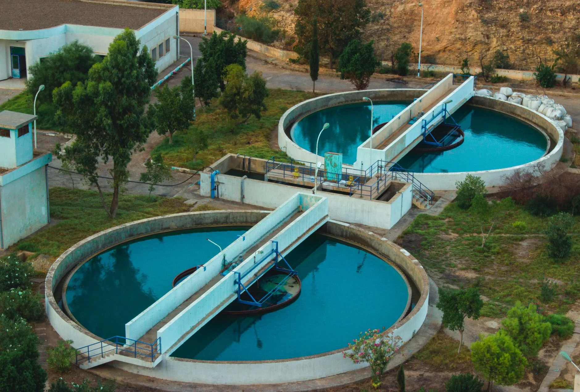 Aerial view of a wastewater treatment plant with large round tanks