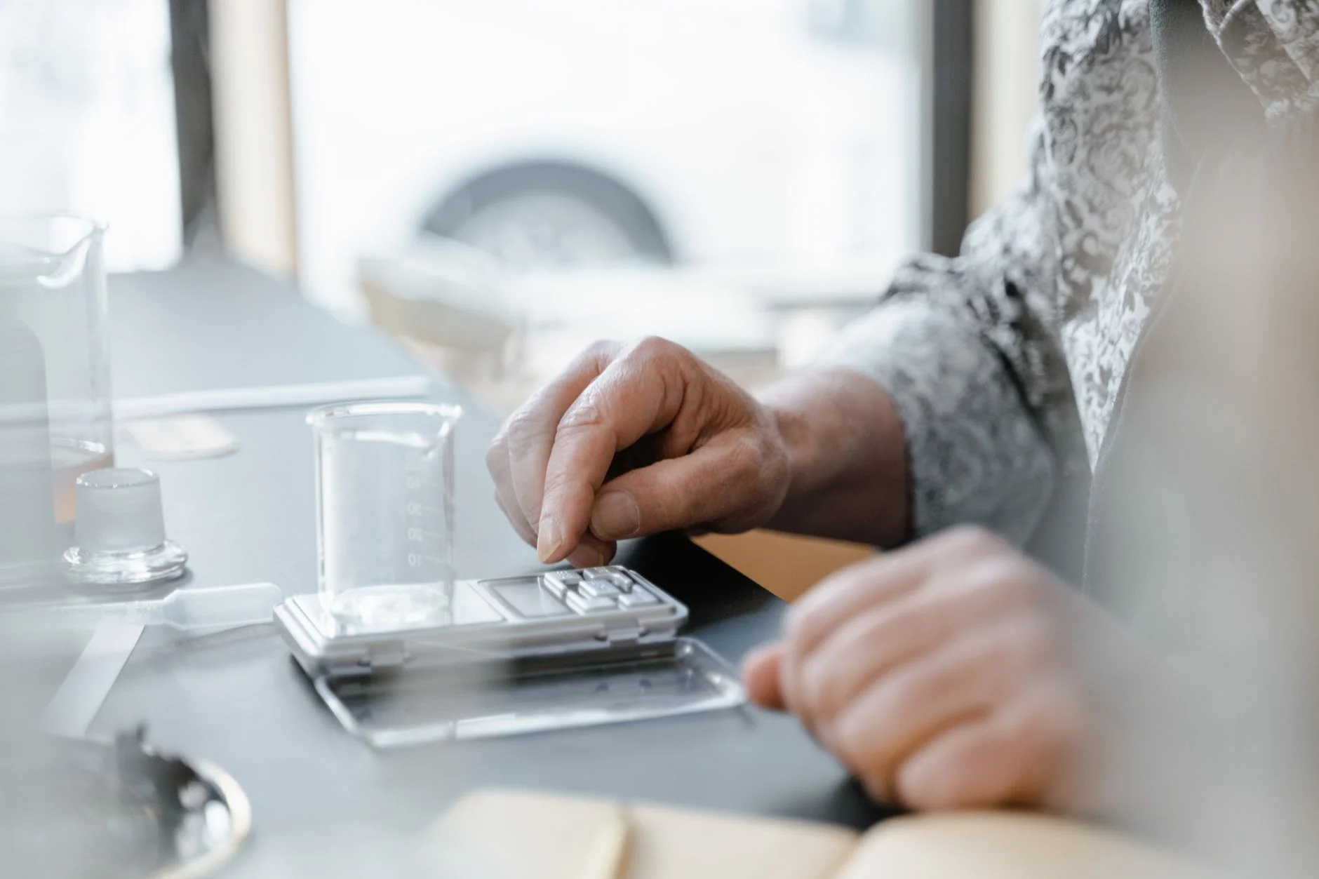 Student weighing a solid on a digital balance in a chemistry lab