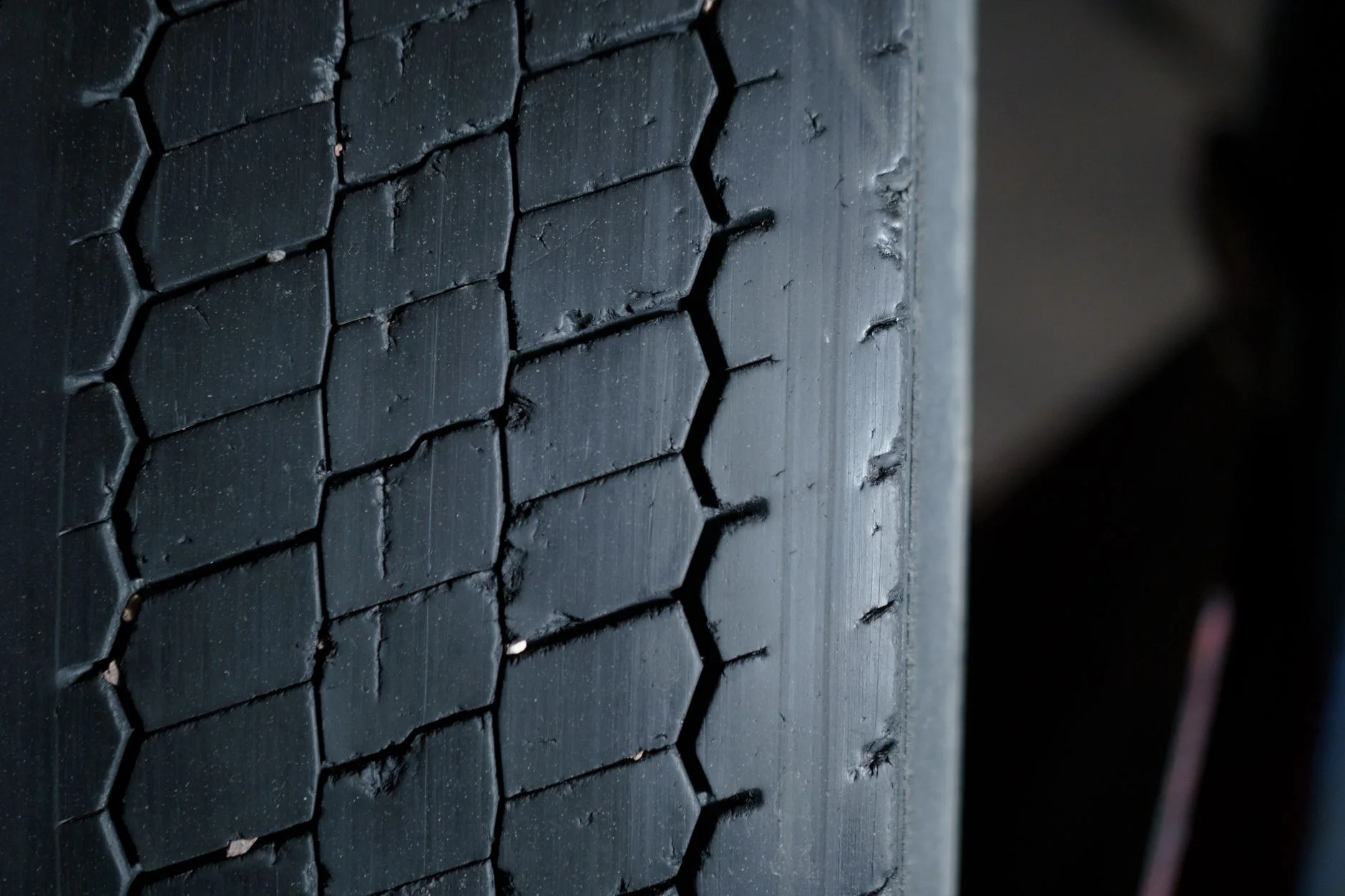 Close-up of the tread blocks on a black rubber tyre